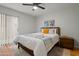 Bright bedroom featuring ceiling fan, closet and comfortable bed with stylish throw blanket at 9445 N 94Th Pl # 102, Scottsdale, AZ 85258