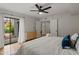 Bright bedroom featuring closet, a bed and a view through sliding glass doors at 9445 N 94Th Pl # 102, Scottsdale, AZ 85258