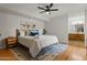 This bedroom is well-lit with art, a bed and a view into the bathroom at 9445 N 94Th Pl # 102, Scottsdale, AZ 85258