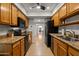 Functional kitchen with wood cabinets, granite countertops, and black appliances at 9445 N 94Th Pl # 102, Scottsdale, AZ 85258