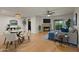 Open-concept living and dining area with a cozy fireplace and sliding patio doors at 9445 N 94Th Pl # 102, Scottsdale, AZ 85258