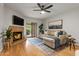 Cozy living room with a fireplace, ceiling fan, and sliding door to the patio at 9445 N 94Th Pl # 102, Scottsdale, AZ 85258