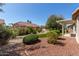 Professionally landscaped backyard with synthetic grass, mature landscaping and covered patio at 13335 W Broken Arrow Dr, Sun City West, AZ 85375