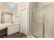 Bathroom featuring single sink with white cabinets and a walk-in shower at 13335 W Broken Arrow Dr, Sun City West, AZ 85375