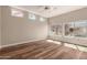 Bedroom with wood floors and an array of windows providing natural light at 13335 W Broken Arrow Dr, Sun City West, AZ 85375