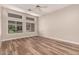 Spacious bedroom with multiple windows and wood flooring, providing ample natural light and views at 13335 W Broken Arrow Dr, Sun City West, AZ 85375