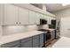 Modern kitchen with white cabinets, stainless steel appliances, and ample counter space at 13335 W Broken Arrow Dr, Sun City West, AZ 85375