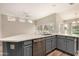 Kitchen island equipped with sink, modern hardware, and stainless-steel dishwasher at 13335 W Broken Arrow Dr, Sun City West, AZ 85375
