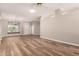 Spacious living room with wood floors and large windows for plenty of natural light at 13335 W Broken Arrow Dr, Sun City West, AZ 85375