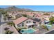 Aerial view of house with solar panels, pool, and mountain backdrop at 13801 N 30Th St, Phoenix, AZ 85032