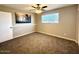 Spacious bedroom featuring a ceiling fan and carpeted flooring at 2044 W 9Th Ave, Apache Junction, AZ 85120