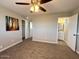 Spacious bedroom with connecting bathroom, plush carpeting, and overhead ceiling fan at 2044 W 9Th Ave, Apache Junction, AZ 85120