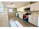 Modern kitchen with white cabinets, stainless steel appliances, and wood-look floors at 2044 W 9Th Ave, Apache Junction, AZ 85120