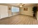 Bright living room with wood floors, a ceiling fan, and a large window at 2044 W 9Th Ave, Apache Junction, AZ 85120