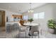 Eat-in kitchen featuring tile floors, a marble table, wooden cabinets, and modern appliances at 11465 E Florian Ave, Mesa, AZ 85208