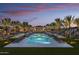 Two sparkling pools with lounge chairs and palm trees at 20428 W Elm Dr, Buckeye, AZ 85396