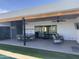 Inviting covered patio with ceiling fans, dining set, and comfortable lounge chairs for outdoor relaxation and entertaining at 7544 E Mckinley St, Scottsdale, AZ 85257