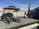 Cozy patio with an umbrella, fire pit, and comfortable seating, perfect for outdoor gatherings and enjoying the weather at 7544 E Mckinley St, Scottsdale, AZ 85257