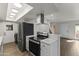 Modern kitchen with stainless steel appliances, breakfast bar, and white cabinetry at 10408 N 11Th St # 2, Phoenix, AZ 85020