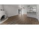 Spacious living room with access to a modern kitchen, kiva fireplace, and vinyl flooring at 10408 N 11Th St # 2, Phoenix, AZ 85020