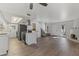 Spacious living area with modern kitchen, staircase, and a cozy kiva fireplace at 10408 N 11Th St # 2, Phoenix, AZ 85020