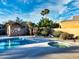 Bright community pool and jacuzzi surrounded by desert landscaping under a partly cloudy sky at 16914 E Britt Ct, Fountain Hills, AZ 85268