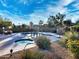 Beautiful pool and jacuzzi with stone landscaping, palm trees, and a gazebo-like structure under a blue sky at 16914 E Britt Ct, Fountain Hills, AZ 85268