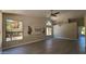 Spacious living area with vaulted ceilings, wood-look tile floors, and large windows at 5452 S Pyrite Cir, Gold Canyon, AZ 85118