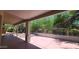 Covered patio with view of backyard and mature trees at 5452 S Pyrite Cir, Gold Canyon, AZ 85118