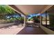 Covered patio provides a shaded outdoor space, overlooking the backyard at 5452 S Pyrite Cir, Gold Canyon, AZ 85118