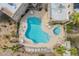 Overhead view of a community swimming pool, hot tub, lounge chairs, palm trees, and building rooftops at 10401 N Saguaro Blvd # 224, Fountain Hills, AZ 85268