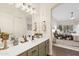 Stylish bathroom with dual sinks, bright vanity lights, and a view into the bedroom at 10401 N Saguaro Blvd # 224, Fountain Hills, AZ 85268