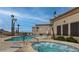 Community swimming pool and hot tub surrounded by well-maintained landscaping, palm trees, and desert scenery at 10401 N Saguaro Blvd # 224, Fountain Hills, AZ 85268