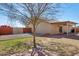 Spacious backyard with a covered patio, mature landscaping, brick accents and access to walking path at 3202 E Decatur St, Mesa, AZ 85213