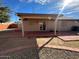 Home's backyard features a covered patio and low maintenance landscaping at 3202 E Decatur St, Mesa, AZ 85213