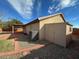 View of the backyard featuring gravel landscaping, a shed, and a covered patio area at 3202 E Decatur St, Mesa, AZ 85213