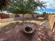 Well landscaped backyard area with fire pit and stone landscaping accents at 3202 E Decatur St, Mesa, AZ 85213