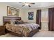 Bedroom with a large bed, dark wood frame, and artistic decor at 3202 E Decatur St, Mesa, AZ 85213