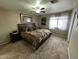 Spacious bedroom featuring neutral tones, carpet flooring, and a ceiling fan at 3202 E Decatur St, Mesa, AZ 85213