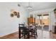 Elegant dining area with a chandelier, a dark wooden table set for four, and a sliding glass door at 3202 E Decatur St, Mesa, AZ 85213