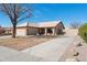 Inviting single-story home featuring a well-maintained tile roof and a spacious driveway leading to a two-car garage at 3202 E Decatur St, Mesa, AZ 85213