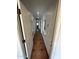 Hallway with decorative tile flooring, arches, and white doors at 3202 E Decatur St, Mesa, AZ 85213
