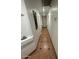 Long hallway has white walls, tile flooring, and recessed lighting at 3202 E Decatur St, Mesa, AZ 85213