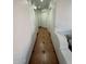 Long hallway featuring tile flooring and white walls at 3202 E Decatur St, Mesa, AZ 85213