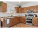Well-lit kitchen featuring stainless steel appliances, double oven, and light-colored cabinets at 3202 E Decatur St, Mesa, AZ 85213