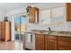 Bright kitchen with stainless steel appliances and sliding glass doors to the backyard at 3202 E Decatur St, Mesa, AZ 85213