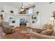 Stylish living room featuring custom shelves, electric fireplace, and a large sectional sofa at 3202 E Decatur St, Mesa, AZ 85213