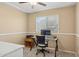 Comfortable office space with a ceiling fan, window for natural light, and desk set for work at 3202 E Decatur St, Mesa, AZ 85213