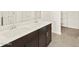 Bathroom featuring double sink vanity, modern faucets, and storage at 3451 E Alexander Dr, San Tan Valley, AZ 85143