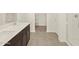 Well-lit bathroom featuring a double sink vanity, tiled floor, and walk in shower at 3451 E Alexander Dr, San Tan Valley, AZ 85143